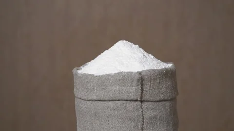 Sack of wheat flour on a brown background Stock Footage 141622740
