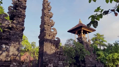 Sacred Bali Temple Mirror Gate with Volcanic Rock and Lush Green Garden during Stock Footage 316896124