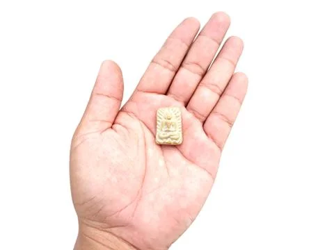 Sacred buddhist clay objects in palm on isolated Stock Photos