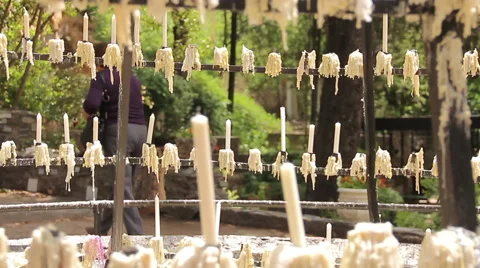 Sacred center of prayers with pilgrims lighting candles asking for miracles Stock Footage 40051429