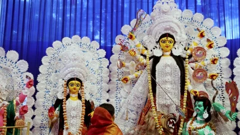 Sacred durga idol display with praying devotee at dussehra celebration in day Stock Footage 314781482