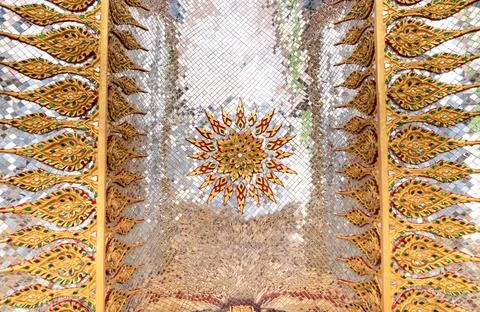 Sacred geometric ceiling pattern inside a Thai temple featuring symmetrical.. 스톡 사진