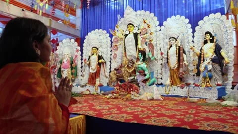 Sacred hindu deity durga idol display with devotee folding in daylight duri.. Stock Footage 314781517