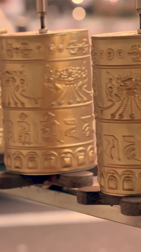 A sacred message is written on a spinning Prayer wheel with blurred background Stock Footage 272573483