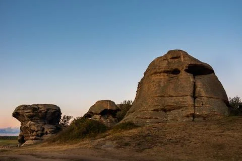 Sacred rocks, mountains in the shape of a head illuminated by the setting sun Stock Photos