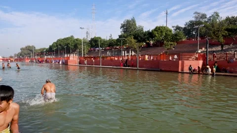 Sacred Sarayu River Ghat with Devotees Performing Holy Bath Rituals in Ayodhya Stock Footage 340814682