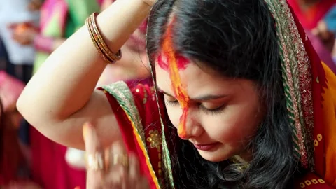 Sacred sindoor offering ritual by devotee at chhath puja celebration Stock Footage 316733954