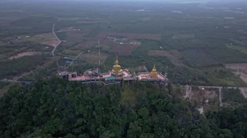 Sacred Tiger Cave Temple rises above misty jungle slopes, Thailand Stock Footage 309802558