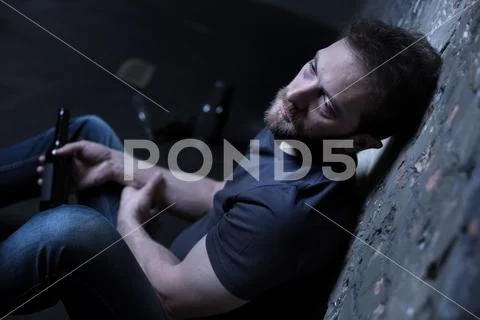 Sad alcoholic expressing desperation indoors Stock Photos