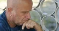 Sad and Depressed Man Sitting on Sidewalk Looking Helpless and Bored 4k or 4k+ Resolution