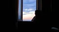 sad and lonely woman looks out the window HD Footage