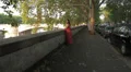 sad and pensive girl with red dress at sunset - steadycam HD Footage