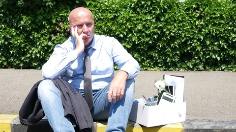 Sad and Perplexed Man Fired from His Job Stay Down on Sidewalk and Drink Water Stock Footage