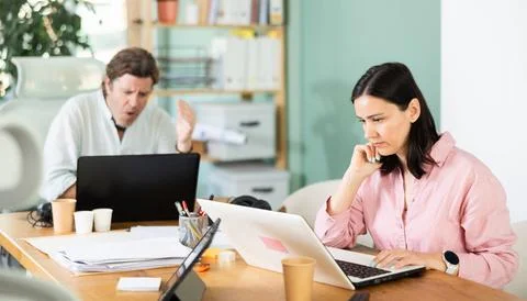 Sad and puzzled man working on laptop with problems in office Stock Photos