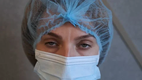 Sad and tired medic opens eyes and looking atraight at camera. medical stuff Video stock 136954872