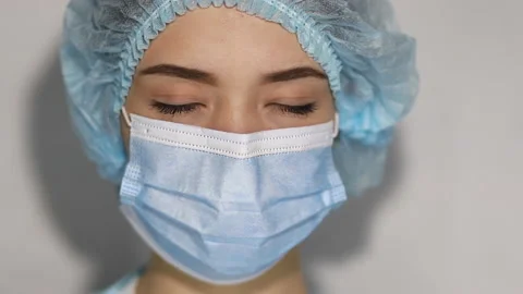 Sad and tired medic opens eyes and looking atraight at camera. Stock Footage 145069735