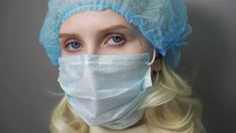 Sad and tired medic opens eyes and looking atraight at camera. medical stuff Video stock 146583966