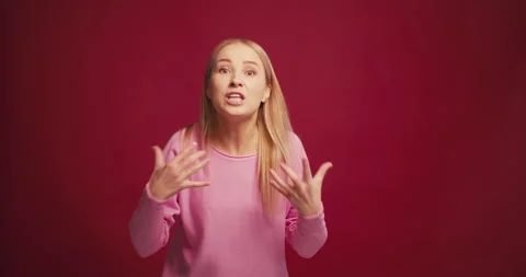 Sad, angry blonde middle aged woman gesturing shouting having bad news isolated Stock Footage 321550194