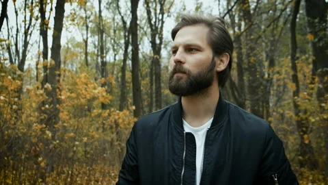 Sad bearded man walking in the park. Depression. Hard days and self-isolation Stock Footage 146980189