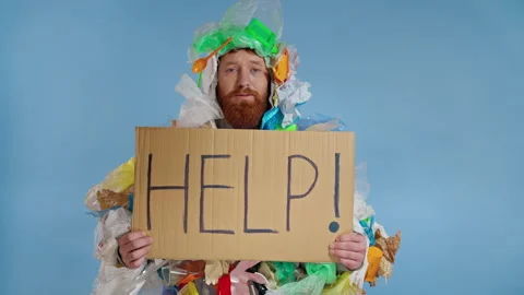 Sad bearded man wearing  garbage costume and holding plate with inscription help Stock Footage 146229762