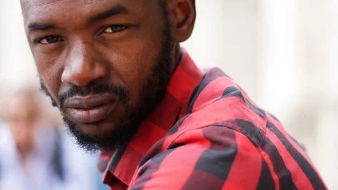 Sad black man looking in camera, outdoor Video stock 82741024