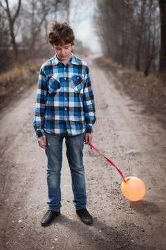 The sad boy with a balloon Stock Photos