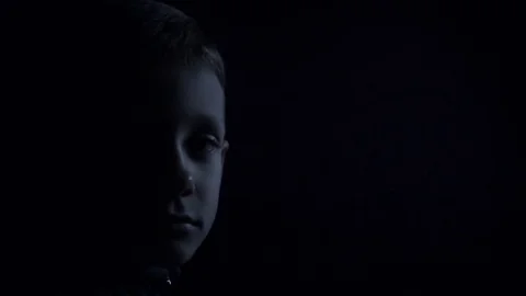 Sad boy close-up: half face in the dark Stock-Footage 80469596