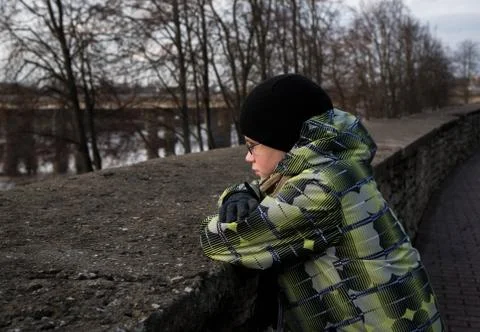 Sad boy looking at the river Stock Photos