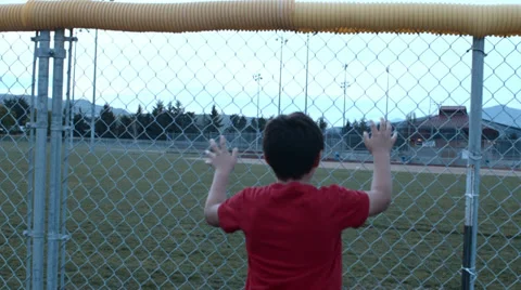 Sad boy looks at baseball field Stock Footage 37408732