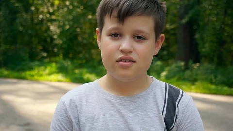 Sad boy looks at the camera. Portrait of sad child looking at the camera Stockbeeldmateriaal 94670461