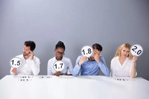 Sad Business People Showing Low Score Cards Stock Photos