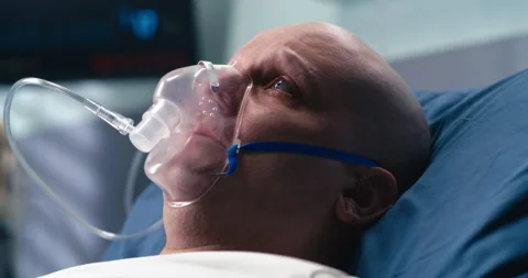 Sad cancer patient breathing oxygen in hospital Stock Footage