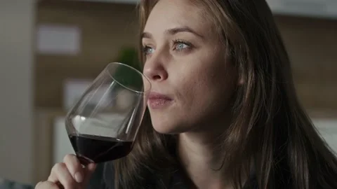 Sad caucasian woman with problems drinking red wine at home Stock Footage 220410012