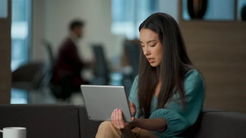 Sad ceo talking pad sitting sofa closeup. Crying director putting tablet couch Stock Footage 228502800