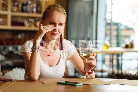 Sad cheerless woman crying in the restaurant Stock Photos