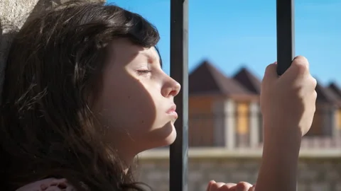 Sad child at the bars Stock Footage 317221815