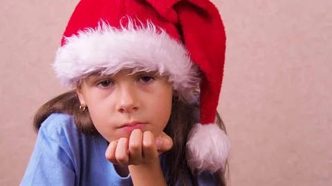 Sad child in a Christmas hat. Stock Footage