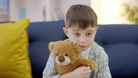 Sad child hugging teddy bear toy, negative emotions, bad memories, problem Stock Footage 149244331