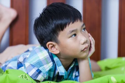 Sad child inside bedroom. Problem families concept. Stock Photos