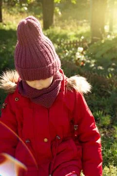 Sad child looking down, outdoors on nature background Stock Photos