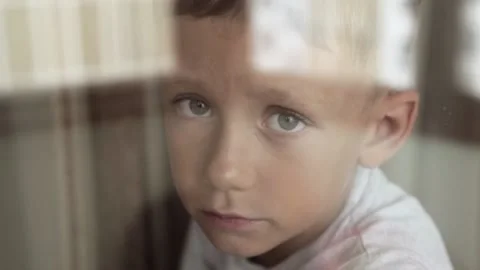 Sad child is watching the window Stock Footage 172438234