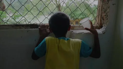 Sad children looking out window - slow motion Stock Footage 146051950