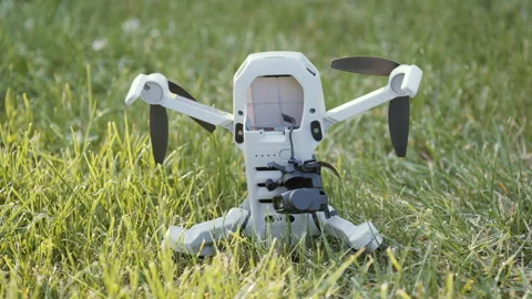 A sad damaged drone on the green grass with a broken camera and gimbal Stock Footage 162529558