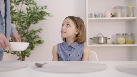 Sad daughter looking at angry father putting bowl on table, parent's attitude Stock Footage