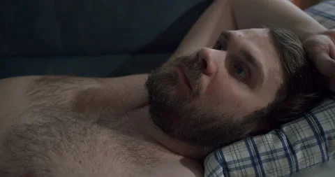 Sad depressed beard man lying on the couch. Unkept, dreamy, pensive look. Think Stock-Footage 237849182