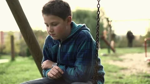 Sad, depressed boy sitting on the swing, slow motion shot at 240fps HD Stock Footage 12226824
