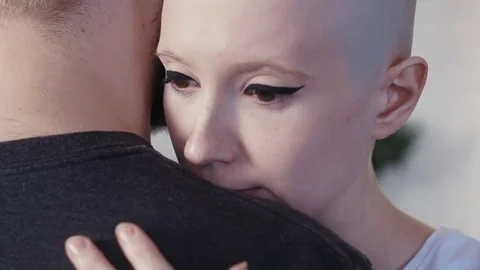 Sad, depressed cancer patient woman hugging her supporting husband Stock Footage