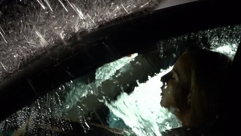 Sad, depressed driver sitting in the car in the rain. Slow motion. Rain drops fa Stock Footage 80388078