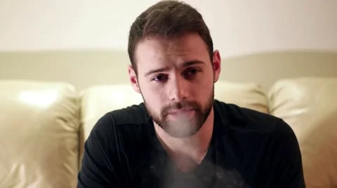 Sad, depressed, handsome young man smoking alone Video stock 59956331