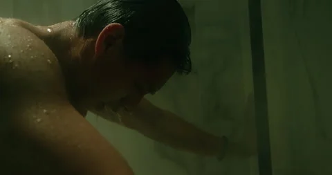 Sad depressed man grieving, screaming in shower under stream of hot water. Stock Footage 338018812
